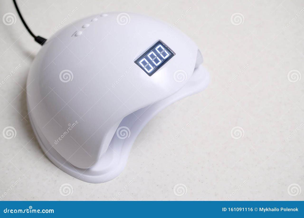 UV LED Nail Lamp for Curing Process by Gel Method Lies on White Table ...